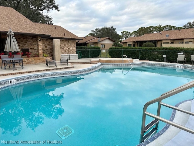 view of swimming pool with a patio area