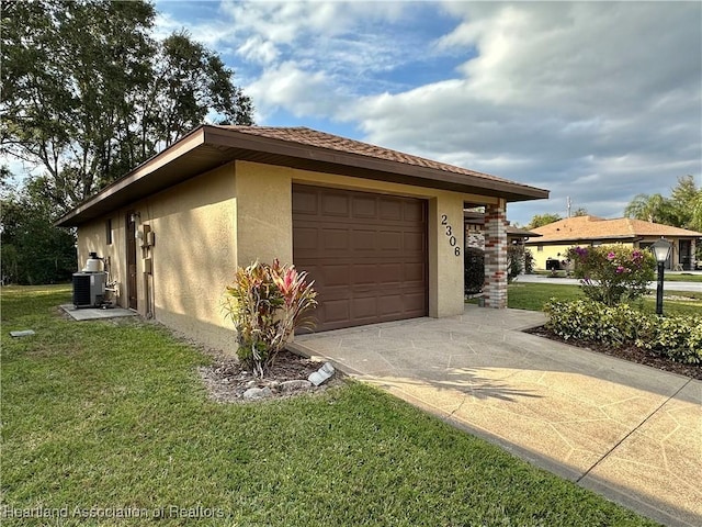 view of property exterior with a yard, cooling unit, and a garage