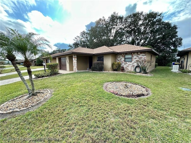 ranch-style house featuring a front yard and a garage