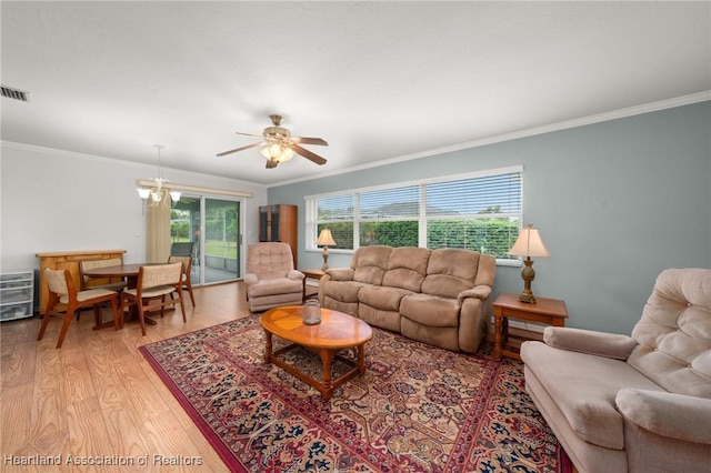 living room with light wood finished floors, visible vents, and ornamental molding