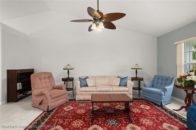 living room with lofted ceiling, carpet, baseboards, and ceiling fan