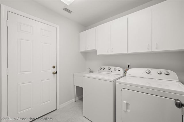 clothes washing area with visible vents, cabinet space, independent washer and dryer, and baseboards