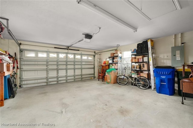 garage featuring electric panel and a garage door opener