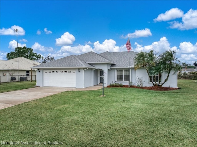 ranch-style house featuring a front yard, fence, driveway, stucco siding, and a garage