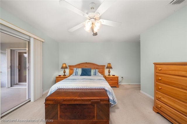 carpeted bedroom featuring visible vents, a ceiling fan, and baseboards