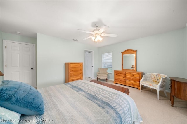 carpeted bedroom with visible vents and a ceiling fan