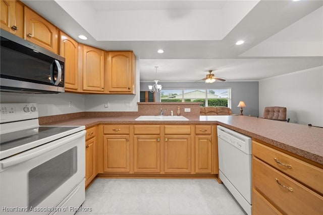 kitchen with white appliances, recessed lighting, ornamental molding, a sink, and ceiling fan with notable chandelier