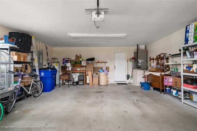 garage with heating unit, a workshop area, water heater, and a garage door opener