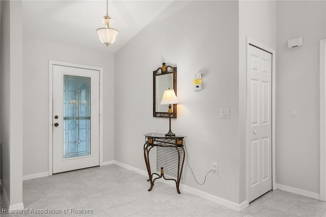 foyer featuring baseboards