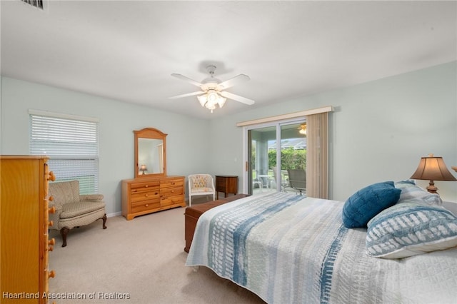 bedroom featuring a ceiling fan, access to exterior, carpet, and visible vents