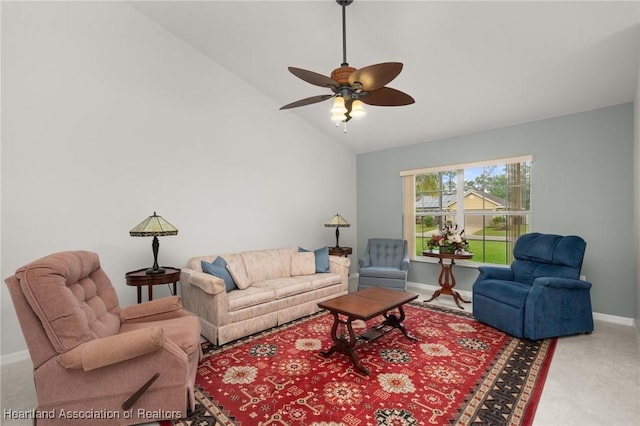 living area with a ceiling fan, baseboards, and vaulted ceiling