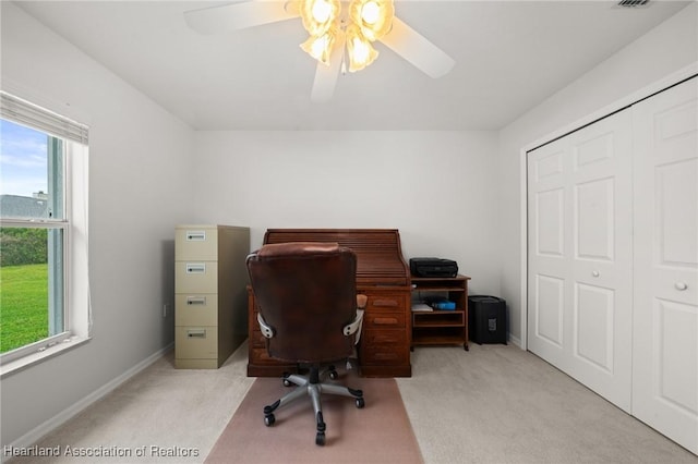 office space with light colored carpet, baseboards, and ceiling fan