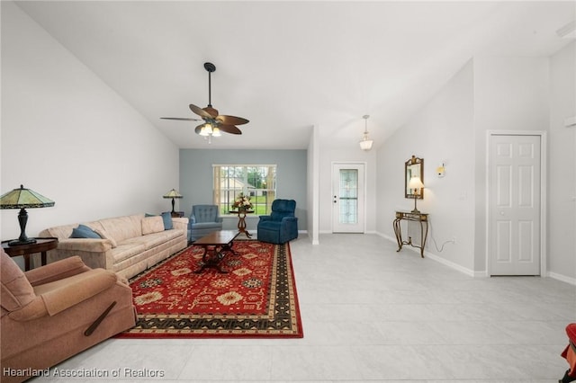 living room featuring baseboards, lofted ceiling, and ceiling fan