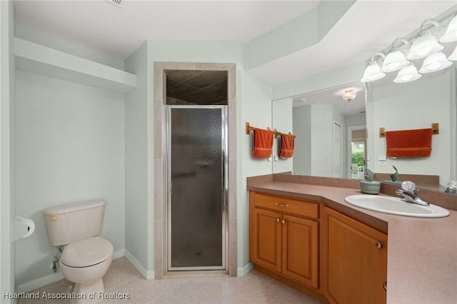 bathroom featuring tile patterned flooring, a shower stall, baseboards, toilet, and vanity