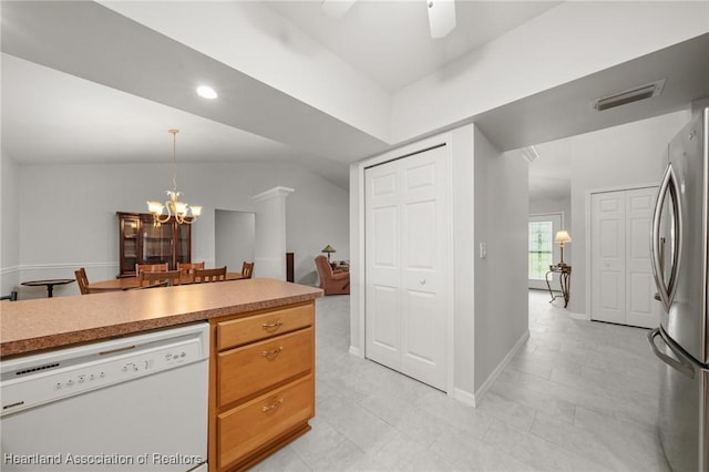 kitchen with visible vents, light countertops, ceiling fan with notable chandelier, freestanding refrigerator, and white dishwasher