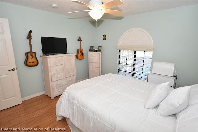 bedroom with ceiling fan and light hardwood / wood-style flooring