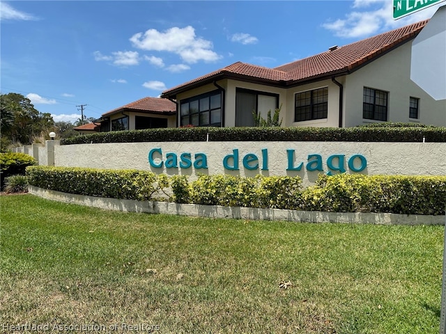 community / neighborhood sign featuring a lawn