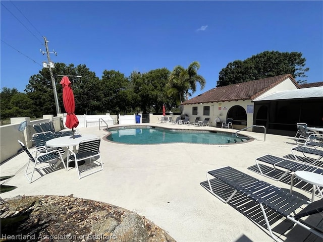 view of swimming pool featuring a patio area