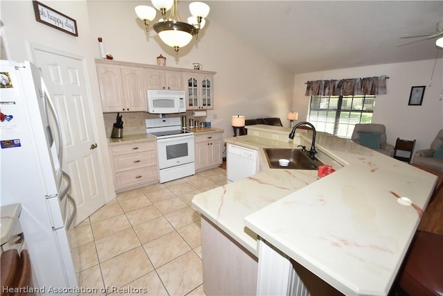 kitchen featuring white appliances, ceiling fan with notable chandelier, sink, hanging light fixtures, and light tile patterned floors