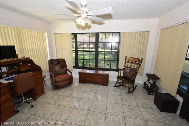 tiled home office featuring ceiling fan