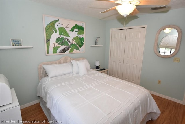 bedroom with ceiling fan, a closet, and wood-type flooring