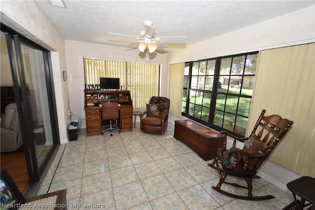 office area featuring a textured ceiling, ceiling fan, and light tile patterned flooring