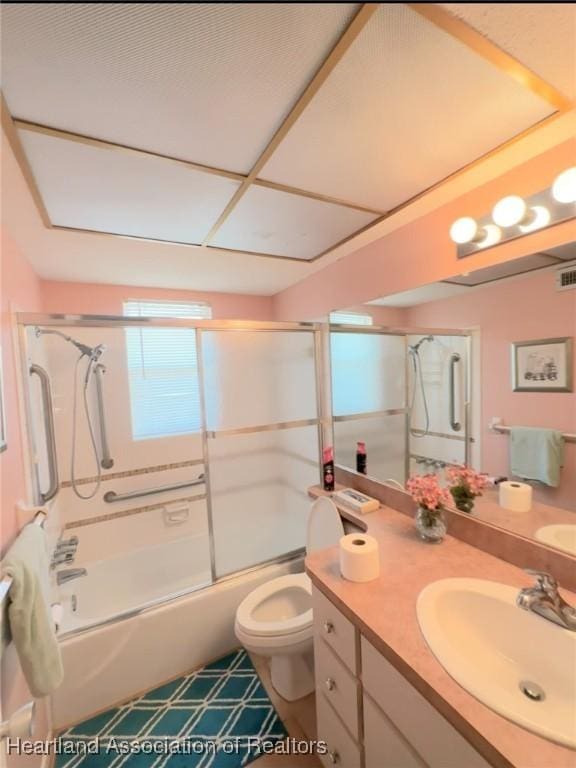 full bathroom with shower / bath combination with glass door, vanity, and toilet