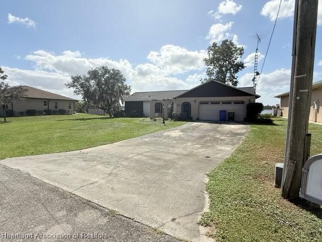 single story home with a front lawn and a garage