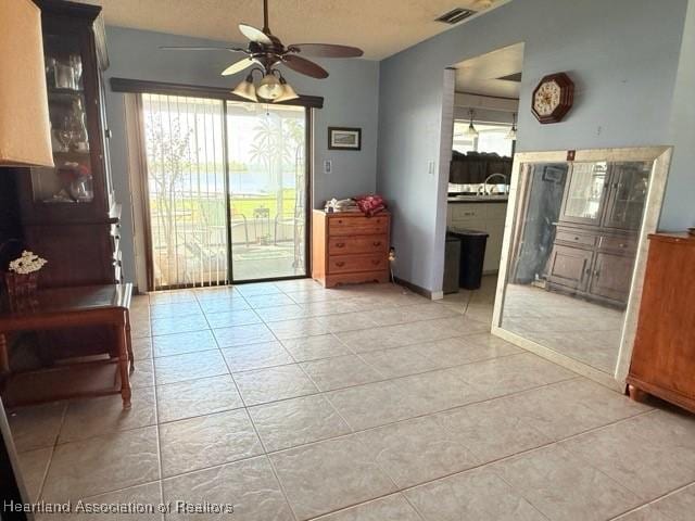 interior space with ceiling fan