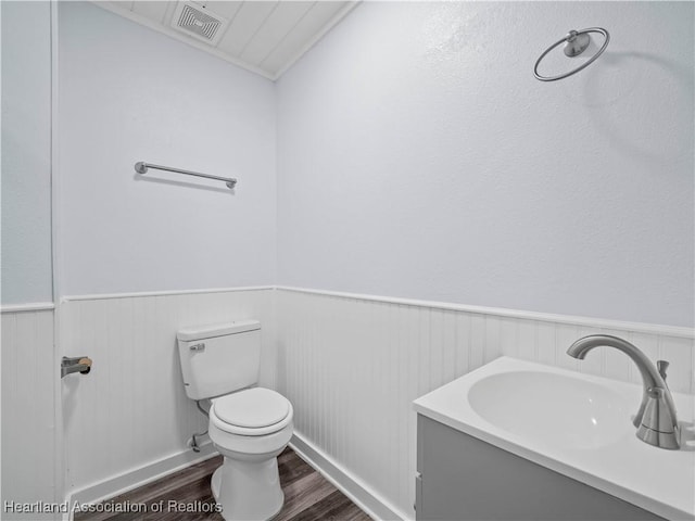 bathroom with hardwood / wood-style flooring, sink, and toilet