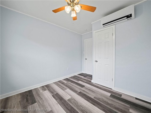 unfurnished bedroom with hardwood / wood-style floors, a wall mounted air conditioner, ceiling fan, and a closet