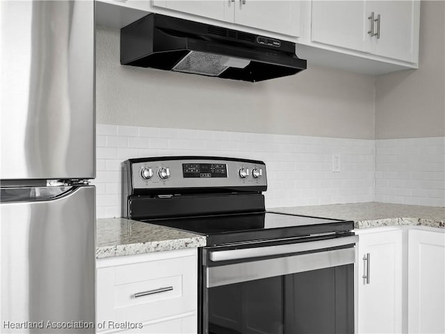 kitchen featuring tasteful backsplash, white cabinetry, appliances with stainless steel finishes, and light stone counters