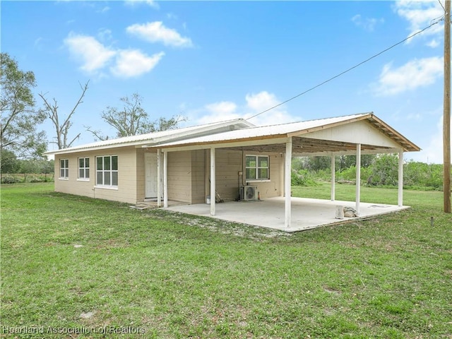 back of property featuring a yard and a patio area