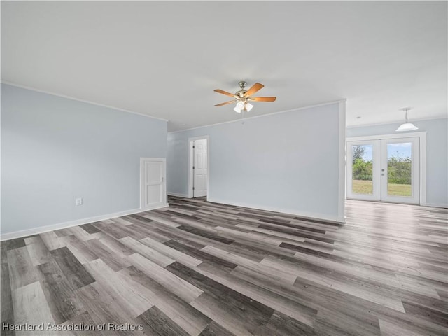 unfurnished living room with hardwood / wood-style flooring, ceiling fan, crown molding, and french doors