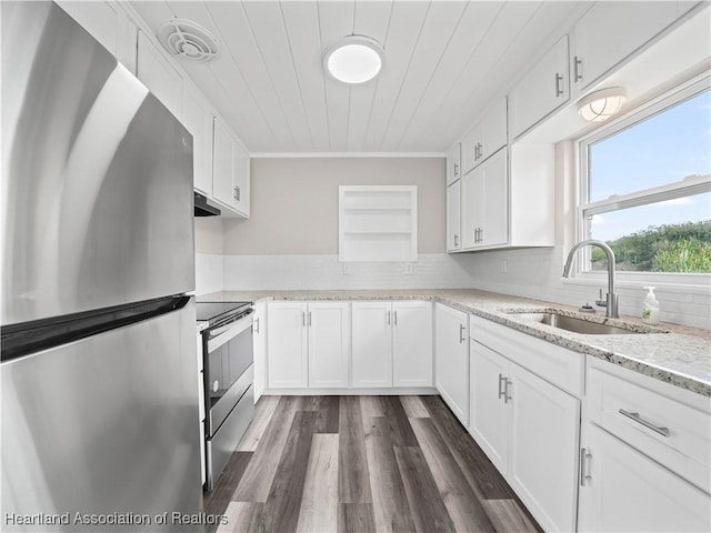 kitchen with sink, ornamental molding, stainless steel appliances, and white cabinets