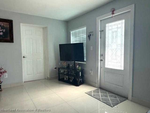 9590 NW 22nd Ave, Miami, FL 33147 - foyer with light tile patterned floors and baseboards