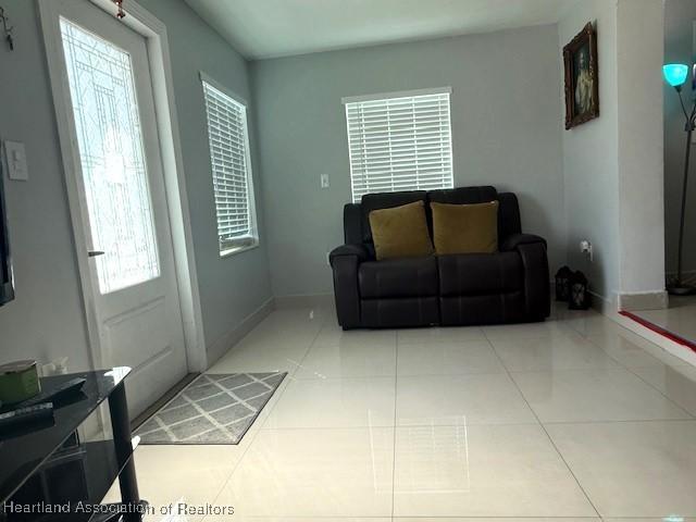 9590 NW 22nd Ave, Miami, FL 33147 - living room with light tile patterned flooring and baseboards