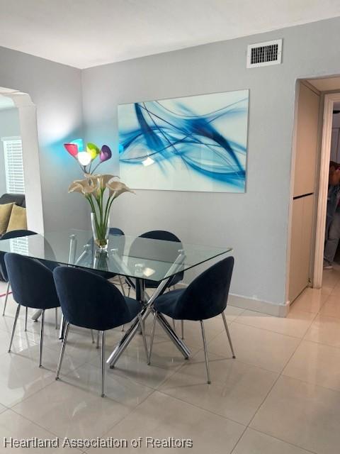 9590 NW 22nd Ave, Miami, FL 33147 - dining space with light tile patterned floors, visible vents, and baseboards