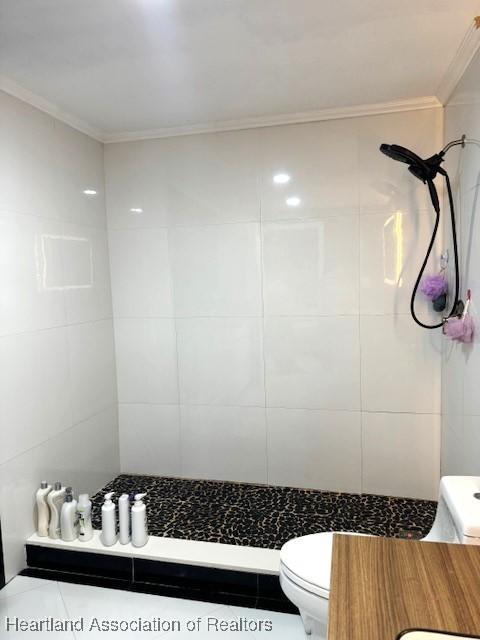 9590 NW 22nd Ave, Miami, FL 33147 - full bath with toilet, tiled shower, ornamental molding, and tile walls