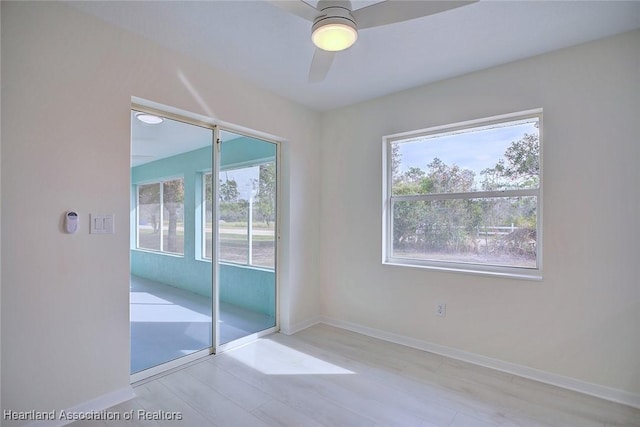 empty room featuring ceiling fan and light wood-type flooring