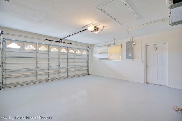 garage with a garage door opener and electric panel