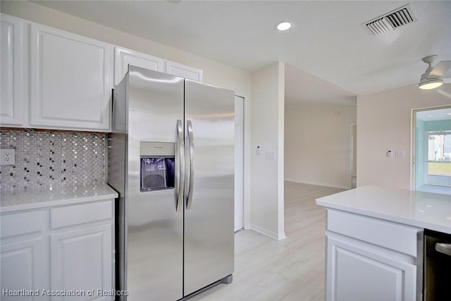 kitchen featuring white cabinetry, tasteful backsplash, and stainless steel refrigerator with ice dispenser