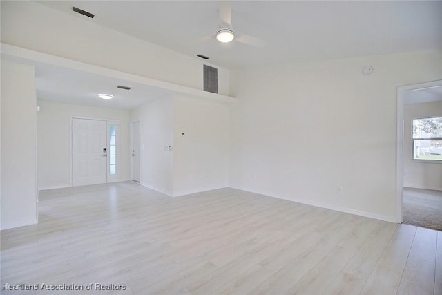 unfurnished room with ceiling fan and light wood-type flooring