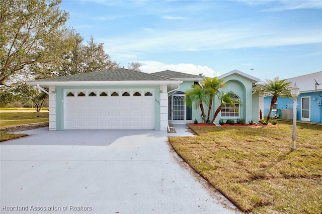 ranch-style house featuring a garage and a front lawn