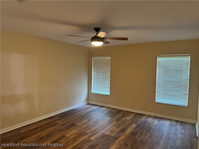 empty room featuring dark hardwood / wood-style flooring and ceiling fan