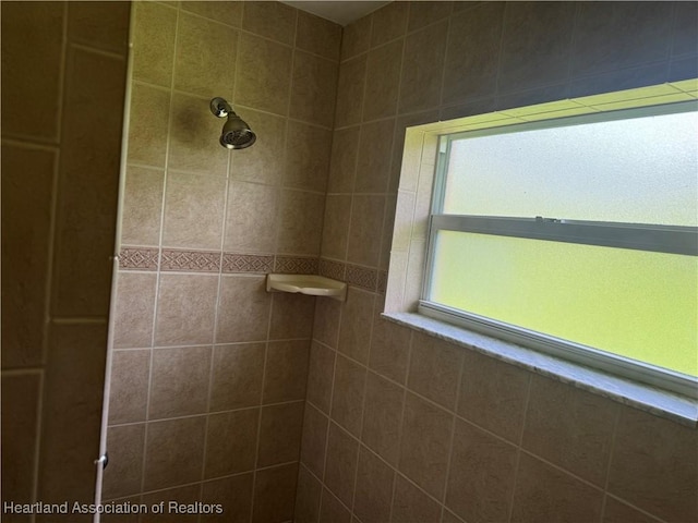 bathroom with tiled shower