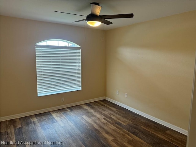 spare room featuring ceiling fan and dark wood-type flooring