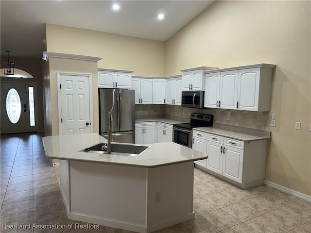 kitchen featuring sink, high vaulted ceiling, backsplash, white cabinets, and appliances with stainless steel finishes