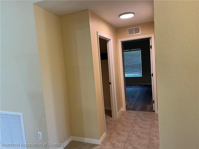 corridor with light tile patterned floors