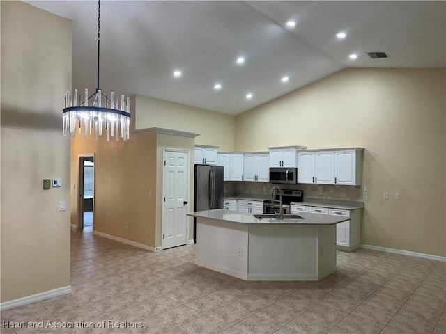 kitchen with sink, stainless steel appliances, an island with sink, decorative light fixtures, and white cabinets